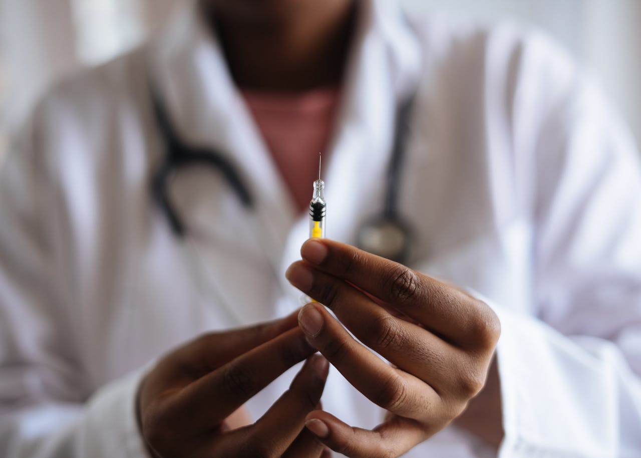 who-we-are Close-up of a healthcare professional holding a syringe, symbolizing medical care and vaccination.